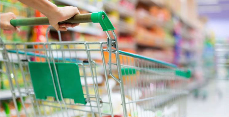 A shopping cart being pushed by one of our helpful employees gathering groceries for your online shopping. order